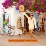 Colorful village street in Formentera with bougainvillea flowers and boutique shops.