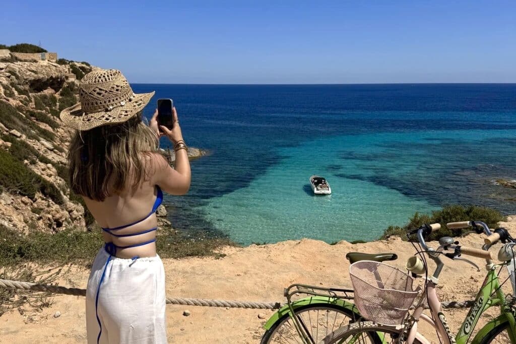 Traveler enjoying a turquoise beach viewpoint in Formentera during a scenic route