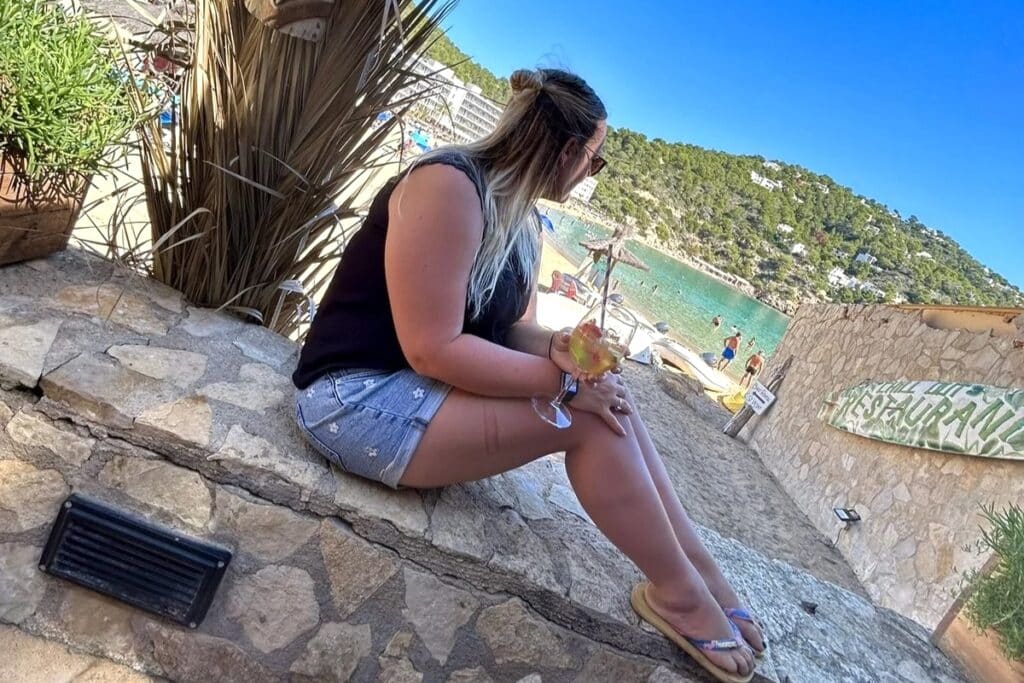 Traveler relaxing at a beach restaurant in Ibiza during a self-drive route