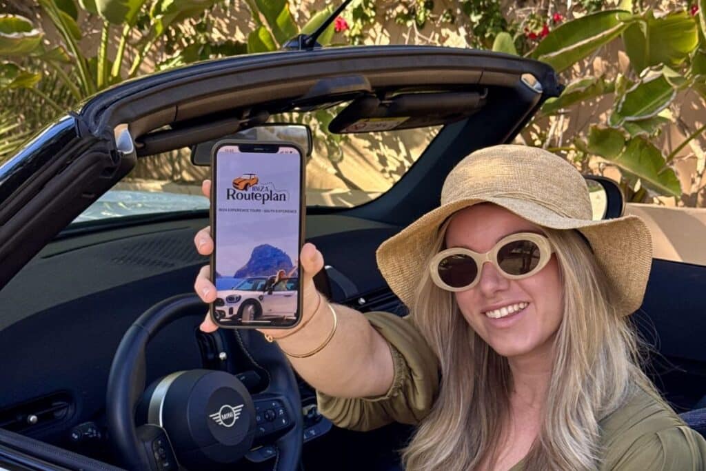 Woman showing ibiza routeplan on her phone during a self-drive road trip in Ibiza