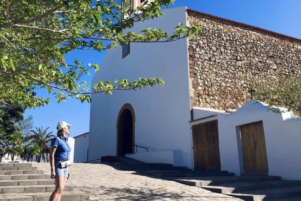 Traveler exploring historic church in san joan in Ibiza during a self-drive route
