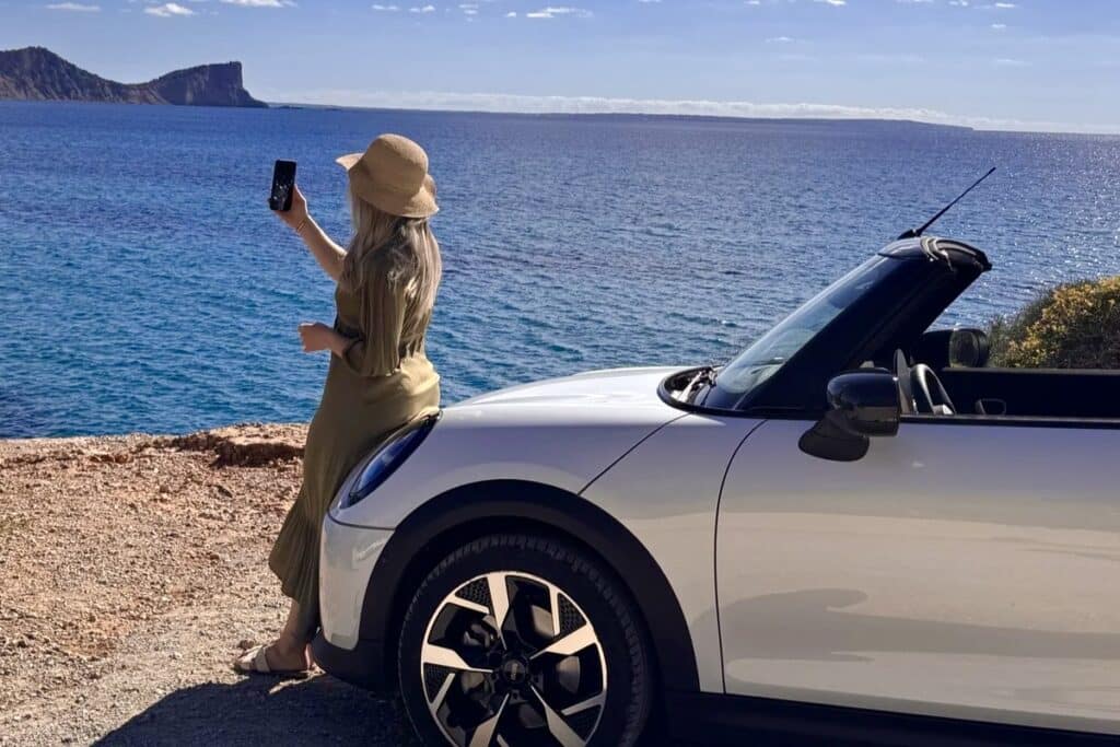 Woman enjoying a coastal viewpoint during an Ibiza self-drive route