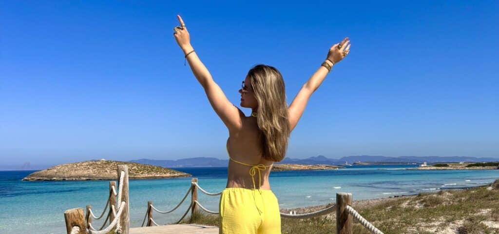 Walking path to a turquoise beach in Formentera during a day trip from Ibiza.